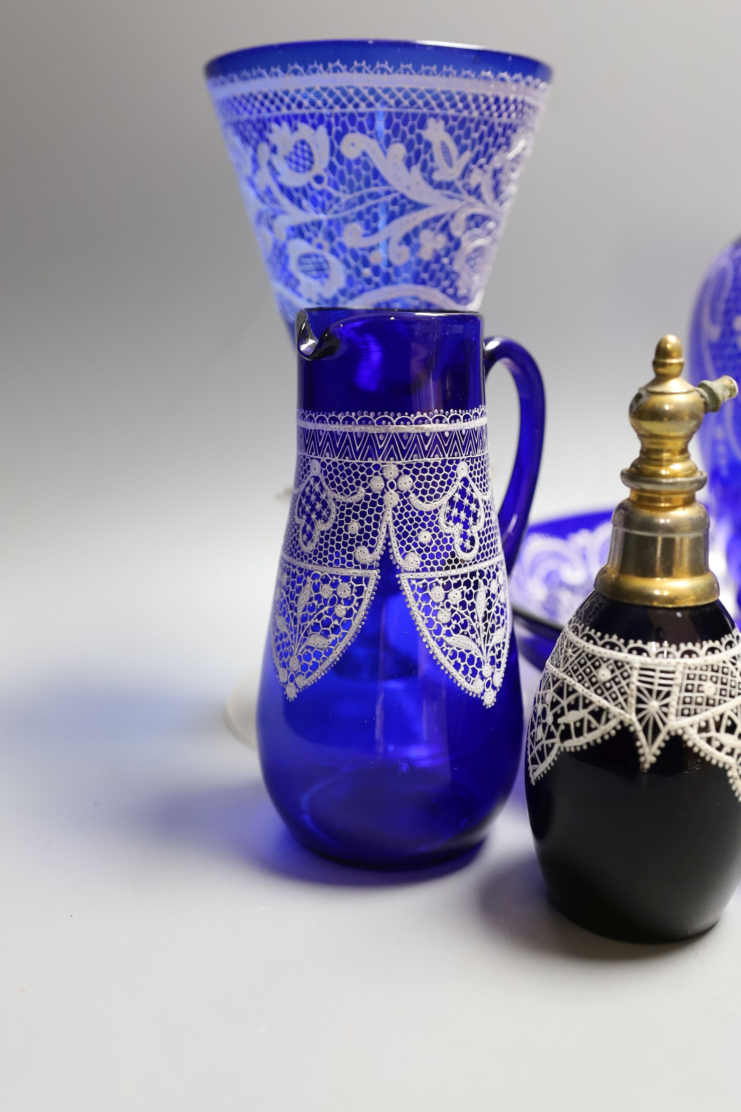 A group of Venetian Lace pattern enamelled blue glass, including a goblet, a vase etc (7)